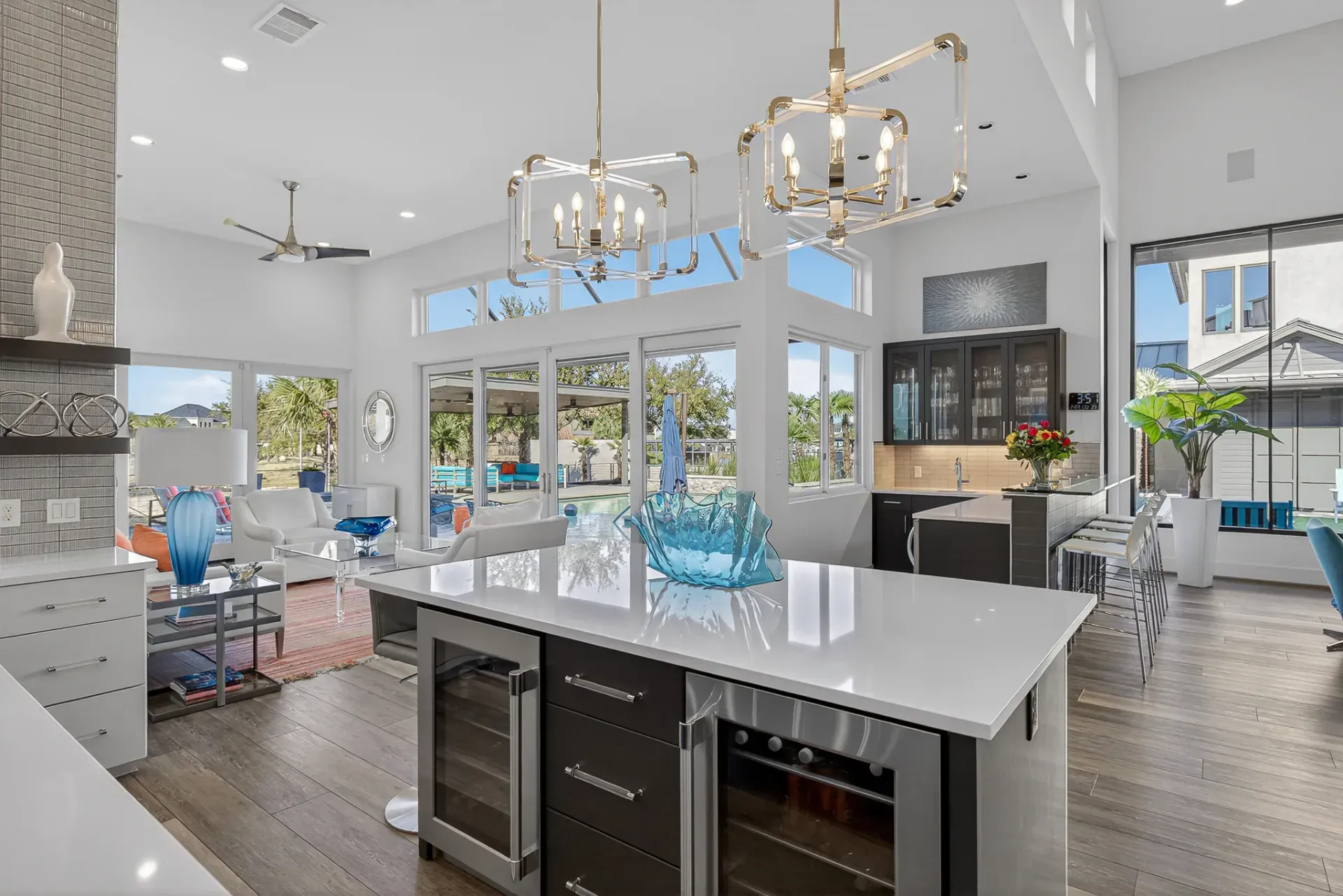 Kitchen island with wine cooler and pool views
